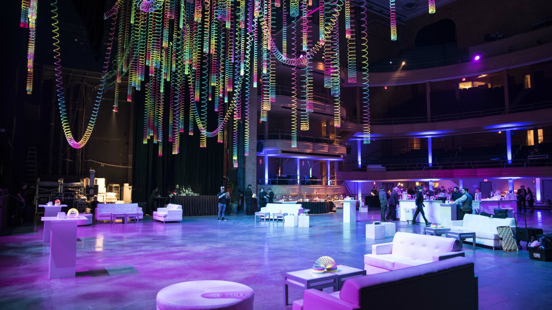 Giant colored slinkies hanging from the ceiling as event decor